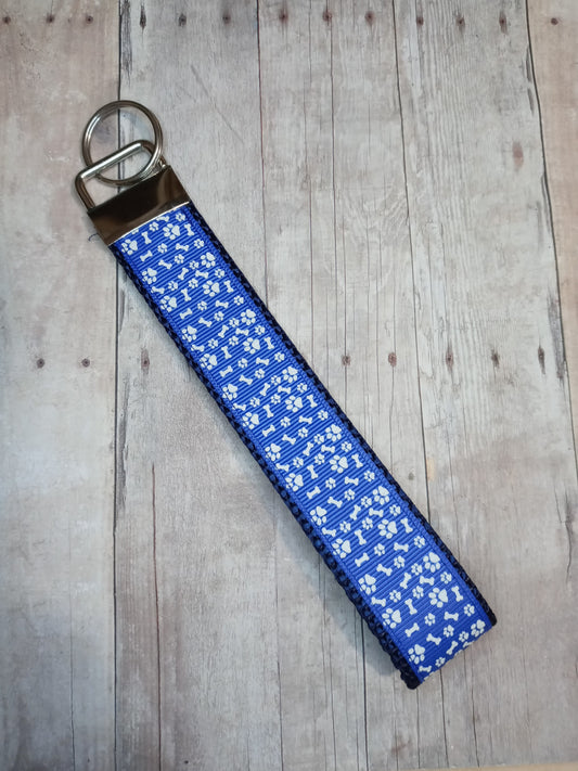 Glow in the dark white paw prints on blue 6" keychain