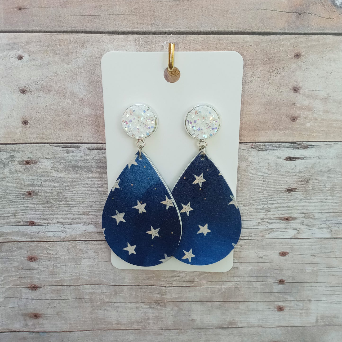 White glitzy druzy with stars on blue dangle earrings