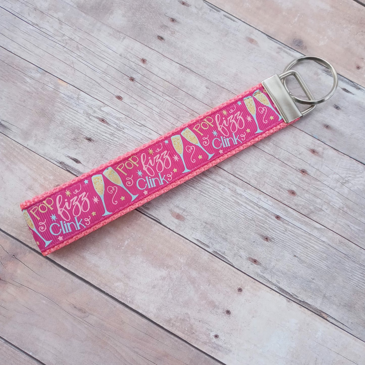 Dark pink Pop, fizz, clink champagne glasses on pink webbing keychain 6"