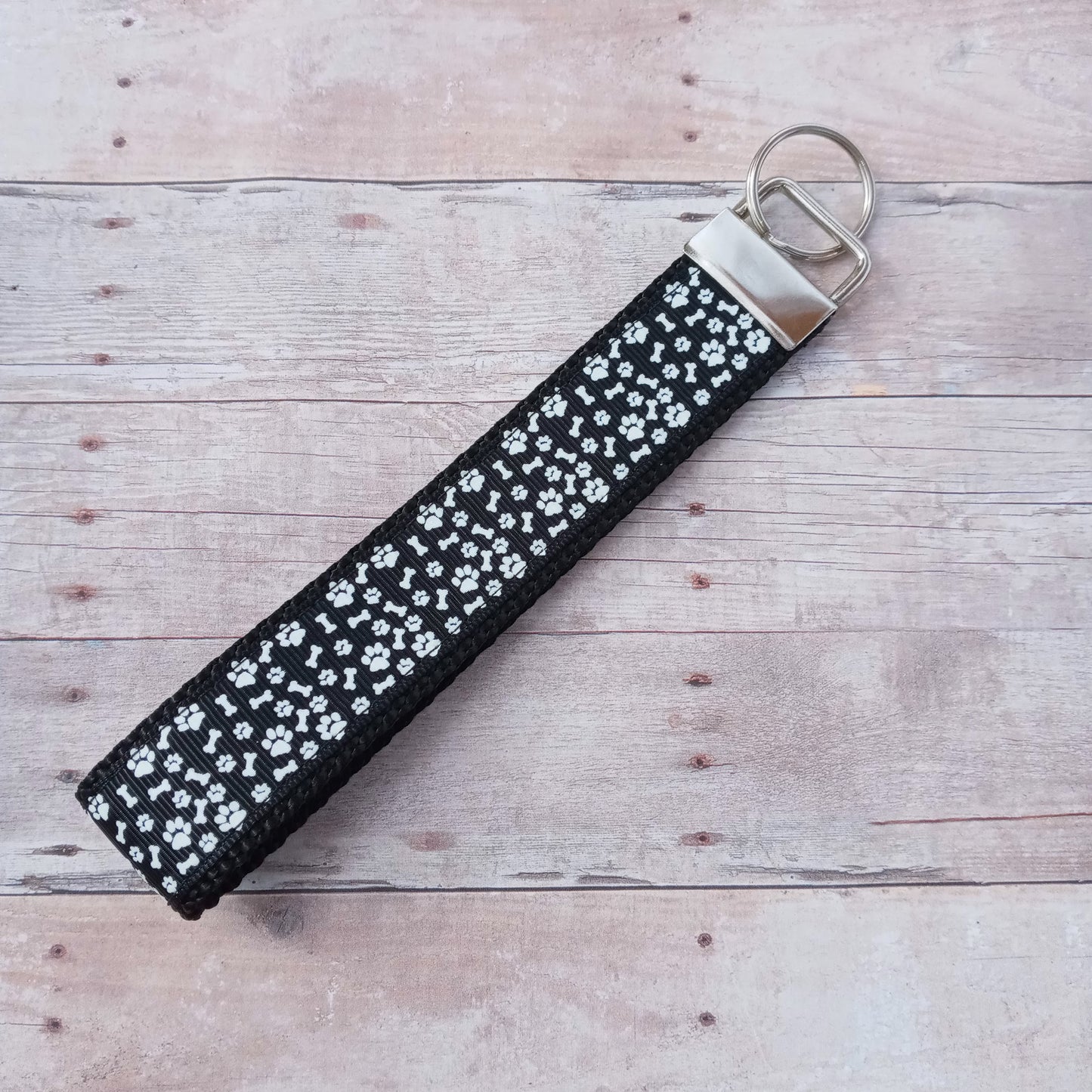 White glow in the dark paw prints on black webbing 6" keychain