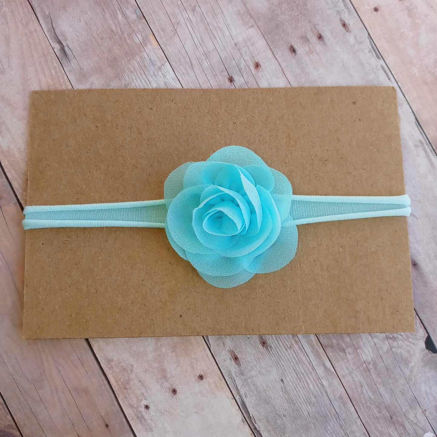 Light blue flower on light blue nylon headband