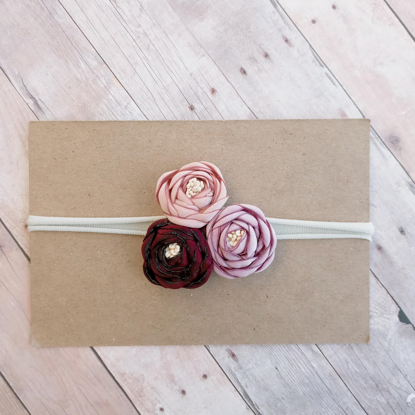 Burgundy, muave, and light purple flower trio on greyish nylon headband